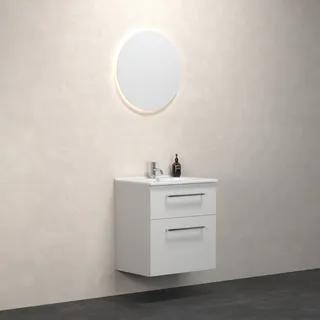 Väggmonterat badrumsskåp med två lådor, ovanför en rund spegel med belysning. En liten flaska står på skåpet.