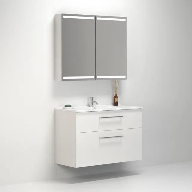 Vitt vägghängt badrumsskåp med två lådor och spegelskåp ovanför; modernt och minimalistiskt utseende.